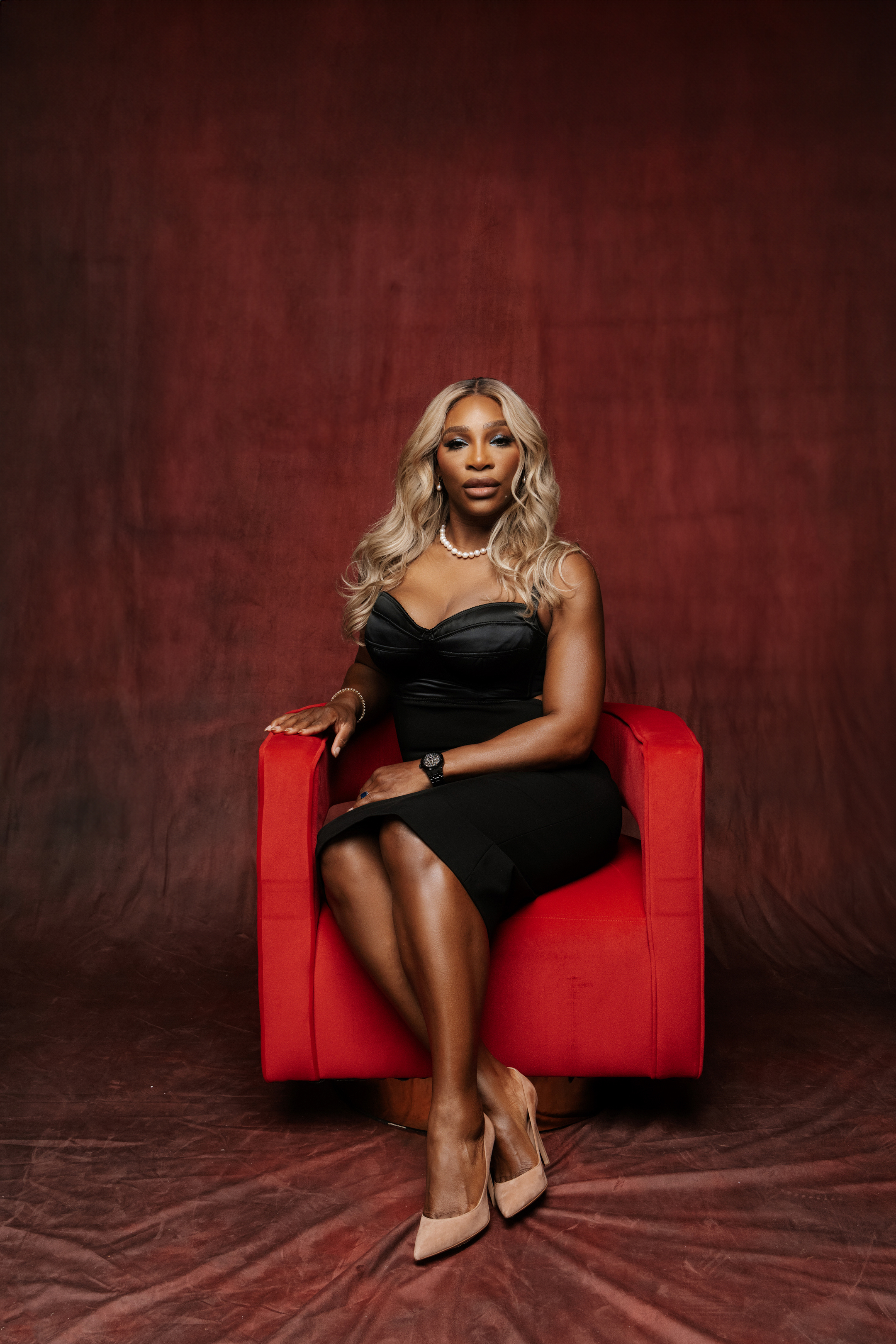 Graduate portrait on a warm cream backdrop